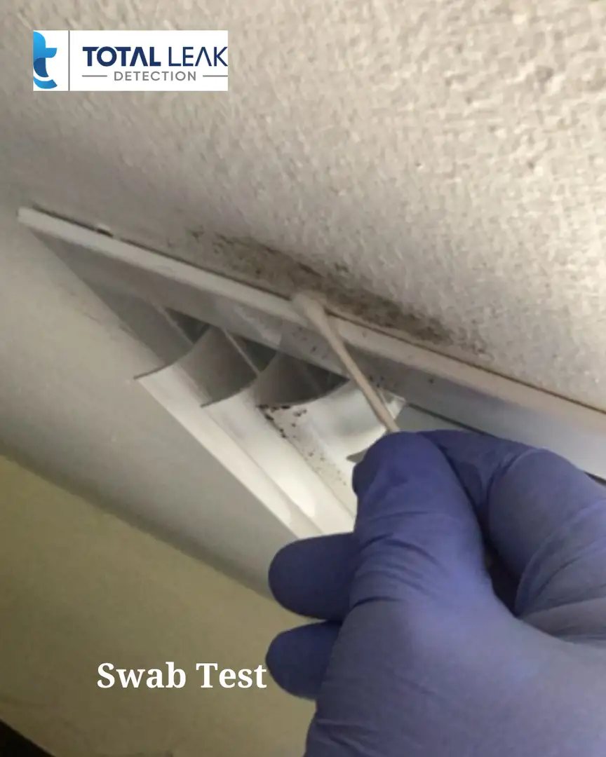 Professional mold inspector performing swab test on air vent during mold testing