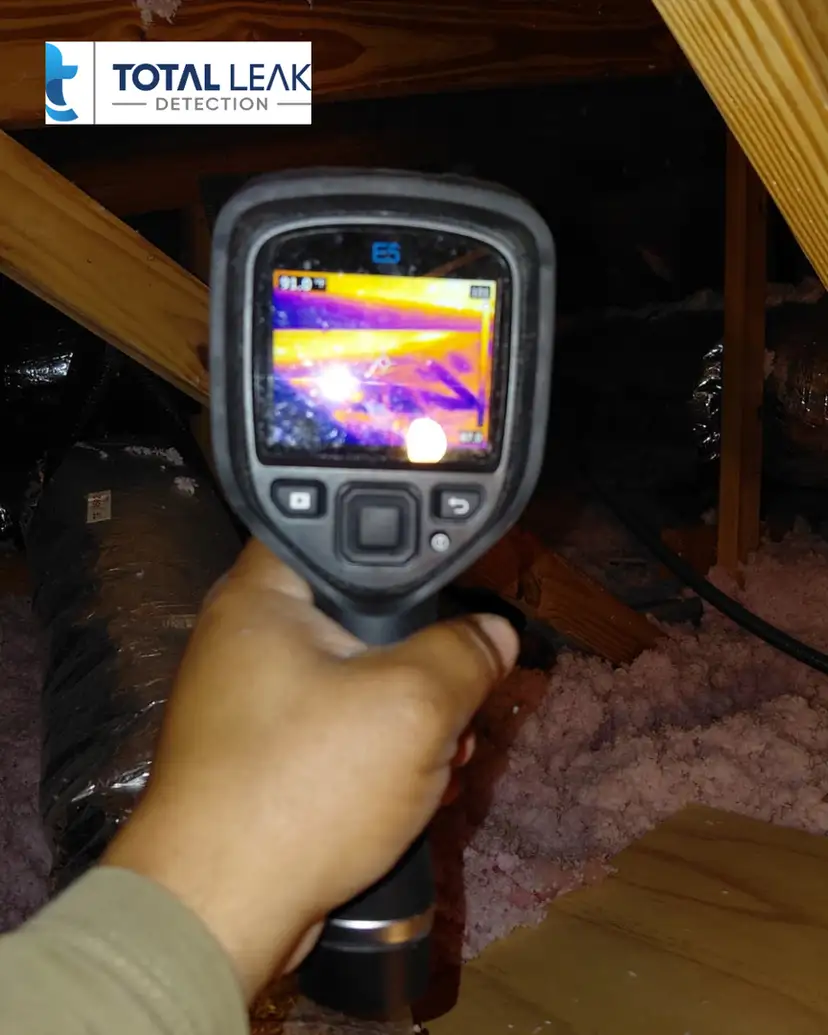 Thermal imaging camera detecting hidden water leaks in attic insulation in Miami-Dade