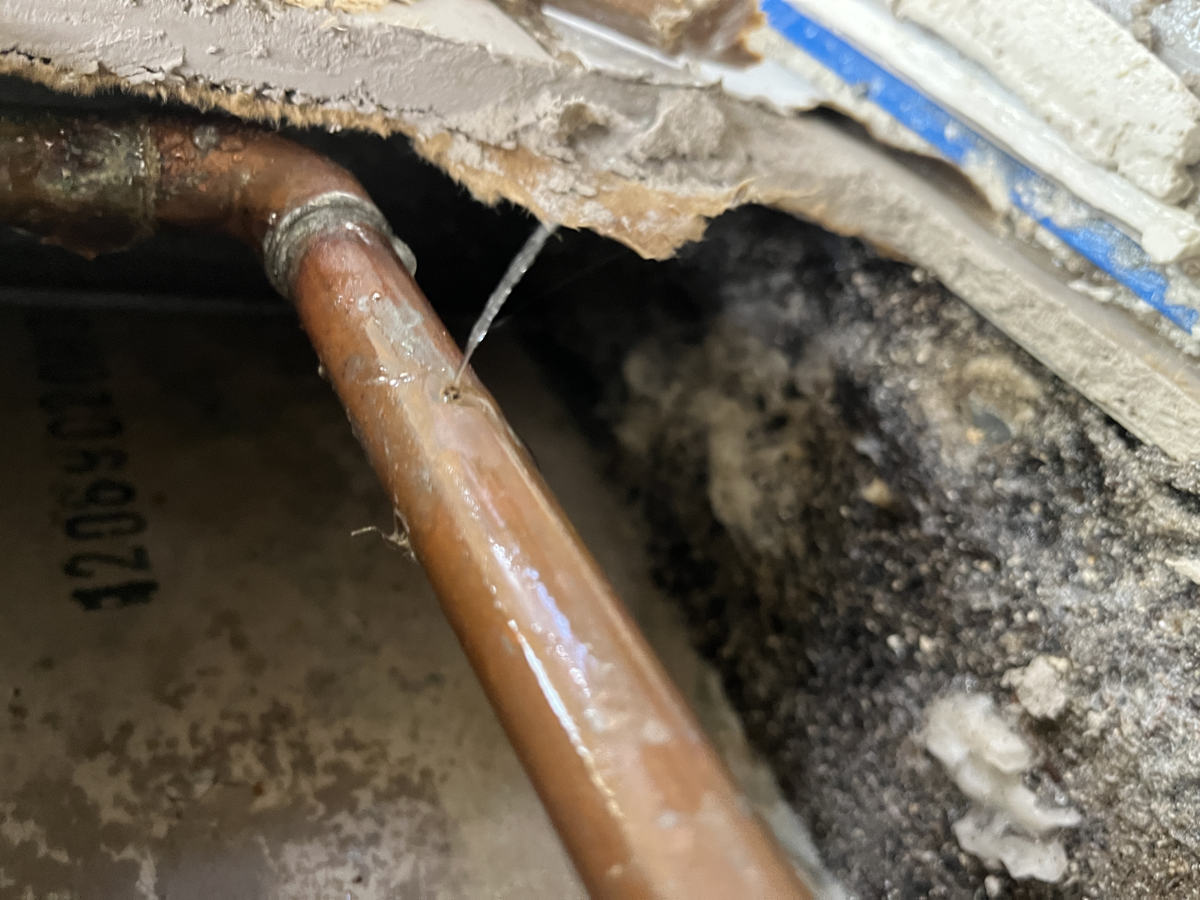 Copper pipe pinhole leak with visible water damage discovered during professional leak detection service in Miramar