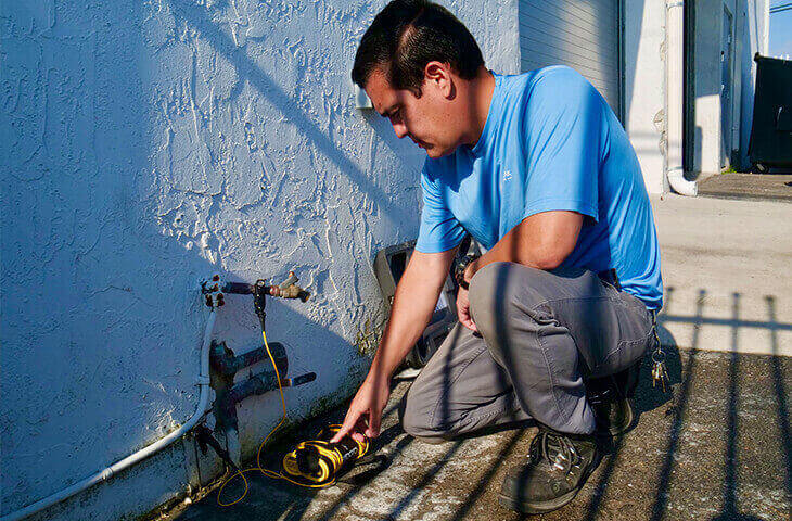 Professional plumber testing water lines during inspection for 48-hour plumbing report delivery