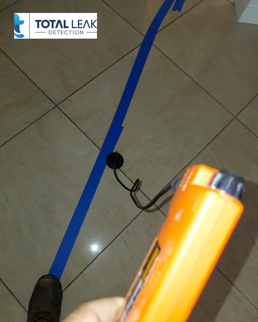 Acoustic leak listening on a tiled floor.